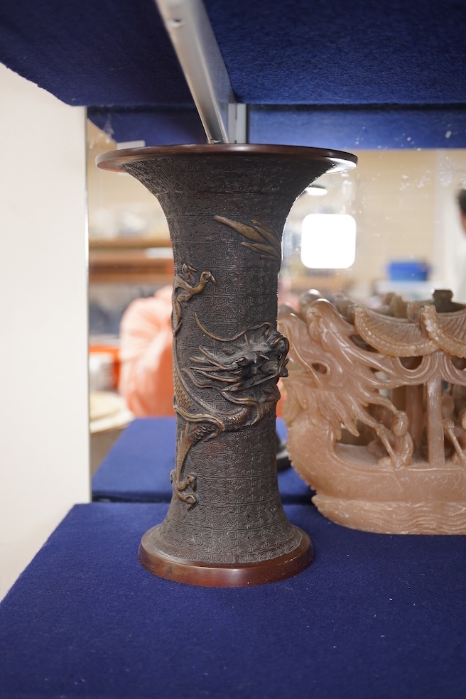 A Japanese bronze dragon vase, Chinese bronze immortal on donkey, and soapstone dragon boat carving, bronze vase 24cm high. Condition - good